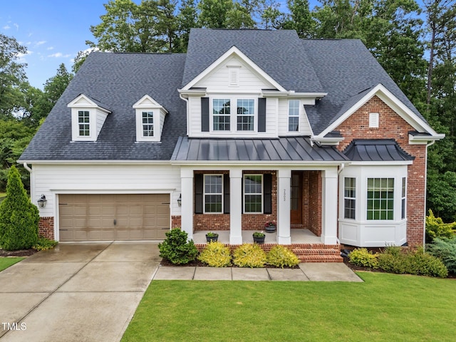 7502 Latteri Ct, Raleigh, NC 27613 - view of front of property with brick siding, covered porch, driveway, a front lawn, and a standing seam roof