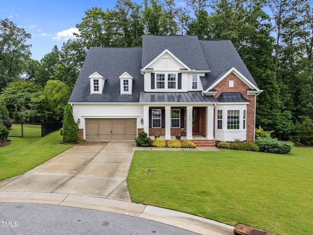 7502 Latteri Ct, Raleigh, NC 27613 - view of front of home with a porch, driveway, brick siding, an attached garage, and a standing seam roof