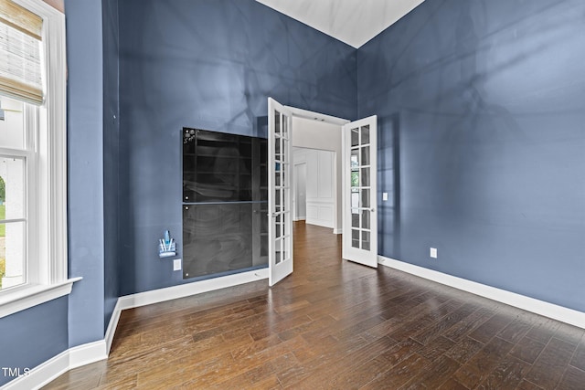 7502 Latteri Ct, Raleigh, NC 27613 - unfurnished room with french doors, wood finished floors, and a high ceiling