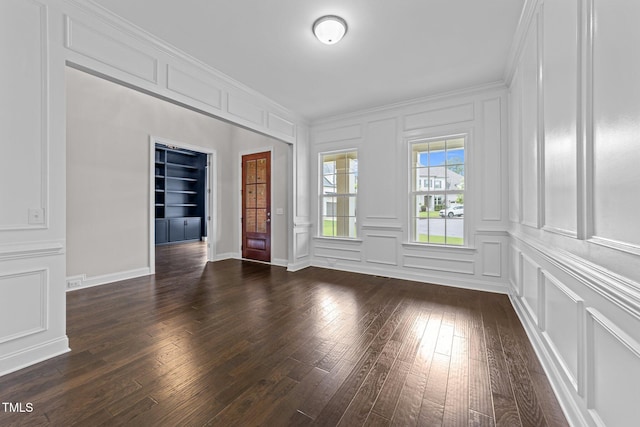 7502 Latteri Ct, Raleigh, NC 27613 - unfurnished room with a decorative wall, built in features, dark wood-style floors, and ornamental molding