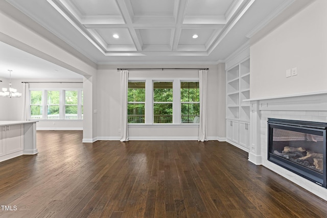 7502 Latteri Ct, Raleigh, NC 27613 - unfurnished living room featuring a brick fireplace, a chandelier, dark wood-style floors, crown molding, and beamed ceiling