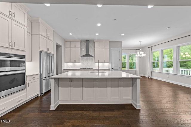 7502 Latteri Ct, Raleigh, NC 27613 - kitchen featuring wall chimney range hood, stainless steel appliances, a chandelier, healthy amount of natural light, and recessed lighting