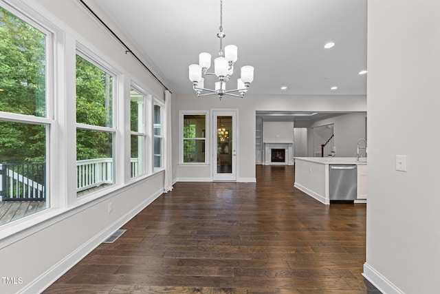 7502 Latteri Ct, Raleigh, NC 27613 - unfurnished dining area with dark wood-style flooring, a chandelier, recessed lighting, and a fireplace