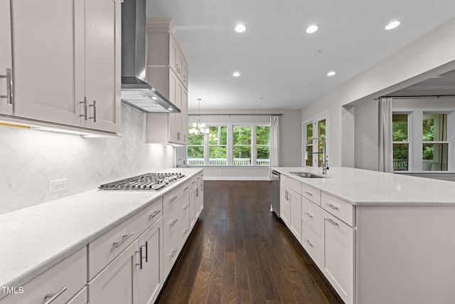 7502 Latteri Ct, Raleigh, NC 27613 - kitchen featuring wall chimney range hood, appliances with stainless steel finishes, dark wood-type flooring, tasteful backsplash, and recessed lighting