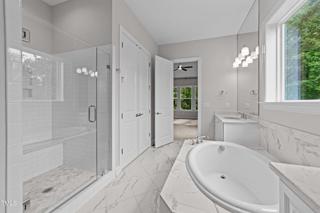 7502 Latteri Ct, Raleigh, NC 27613 - full bathroom featuring vanity, marble finish floors, a stall shower, a garden tub, and ceiling fan