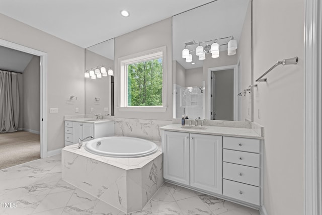 7502 Latteri Ct, Raleigh, NC 27613 - full bathroom featuring marble finish flooring, two vanities, a bath, and recessed lighting