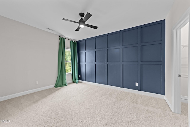 7502 Latteri Ct, Raleigh, NC 27613 - carpeted empty room with a decorative wall and a ceiling fan