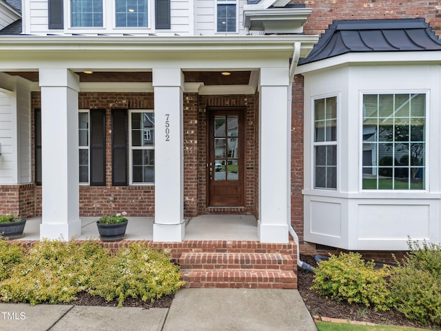7502 Latteri Ct, Raleigh, NC 27613 - view of exterior entry featuring a porch and brick siding
