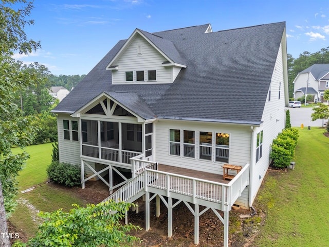 7502 Latteri Ct, Raleigh, NC 27613 - back of property featuring a shingled roof, a sunroom, a lawn, and a deck