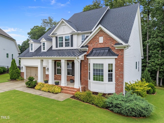 7502 Latteri Ct, Raleigh, NC 27613 - view of front of home with brick siding, a porch, a front lawn, a standing seam roof, and a shingled roof