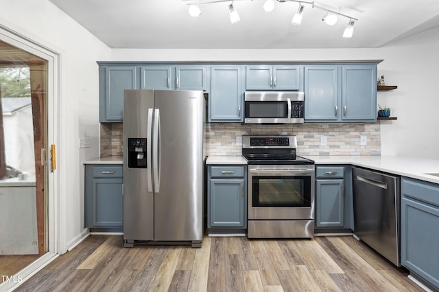 50 Rainwood Ct, Louisburg, NC 27549 - kitchen featuring stainless steel appliances, open shelves, light wood-style flooring, light countertops, and tasteful backsplash