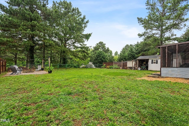 50 Rainwood Ct, Louisburg, NC 27549 - view of yard featuring a sunroom, an outdoor structure, and view of wooded area