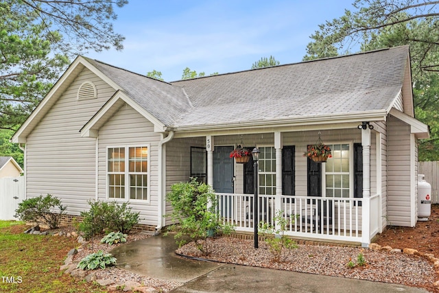 50 Rainwood Ct, Louisburg, NC 27549 - ranch-style home with a porch and a shingled roof