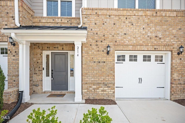 214 George Pine Way, Knightdale, NC 27545 - property entrance featuring brick siding, a garage, and board and batten siding