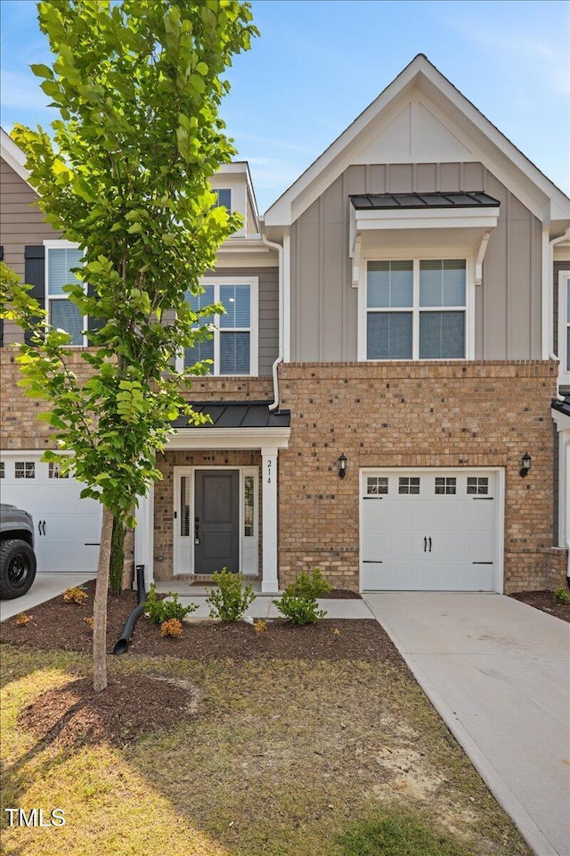 214 George Pine Way, Knightdale, NC 27545 - view of front of home featuring board and batten siding, driveway, brick siding, and an attached garage