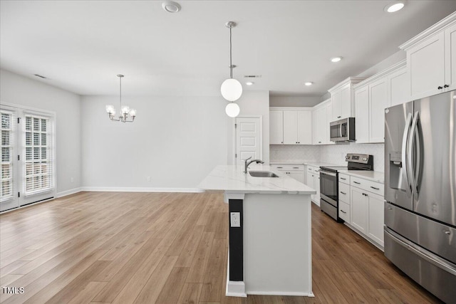 214 George Pine Way, Knightdale, NC 27545 - kitchen with appliances with stainless steel finishes, a sink, a chandelier, white cabinetry, and recessed lighting