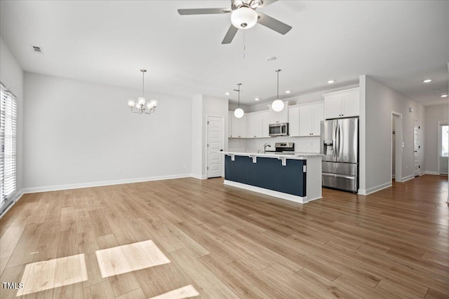 214 George Pine Way, Knightdale, NC 27545 - kitchen featuring stainless steel appliances, a kitchen breakfast bar, recessed lighting, a chandelier, and open floor plan