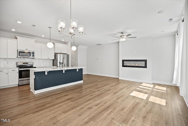 214 George Pine Way, Knightdale, NC 27545 - kitchen with stainless steel appliances, a ceiling fan, open floor plan, recessed lighting, and tasteful backsplash