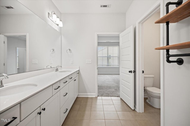 214 George Pine Way, Knightdale, NC 27545 - full bathroom with double vanity, toilet, tile patterned floors, and baseboards