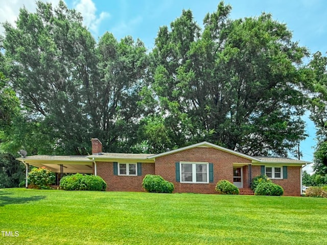 9455 Boston Rd, Roxboro, NC 27574 - single story home with brick siding, a front yard, a chimney, and a carport