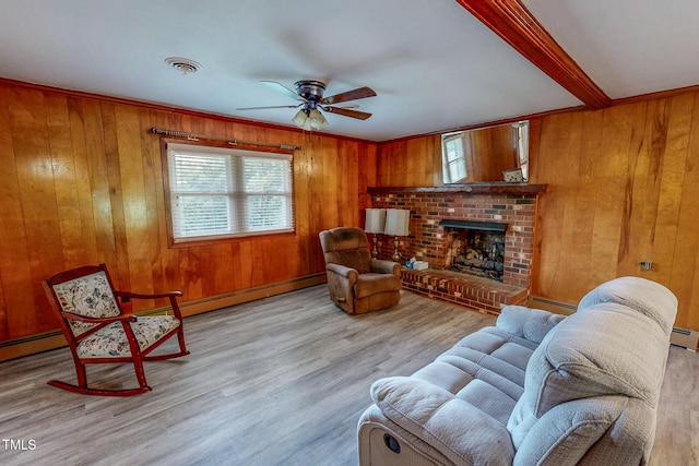 9455 Boston Rd, Roxboro, NC 27574 - living area with healthy amount of natural light, wood walls, a brick fireplace, ceiling fan, and wood finished floors