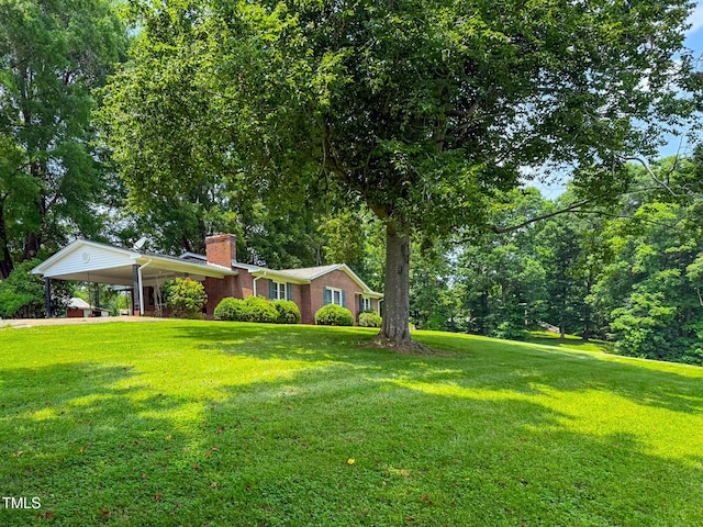 9455 Boston Rd, Roxboro, NC 27574 - ranch-style home with a chimney, a front yard, an attached carport, and brick siding