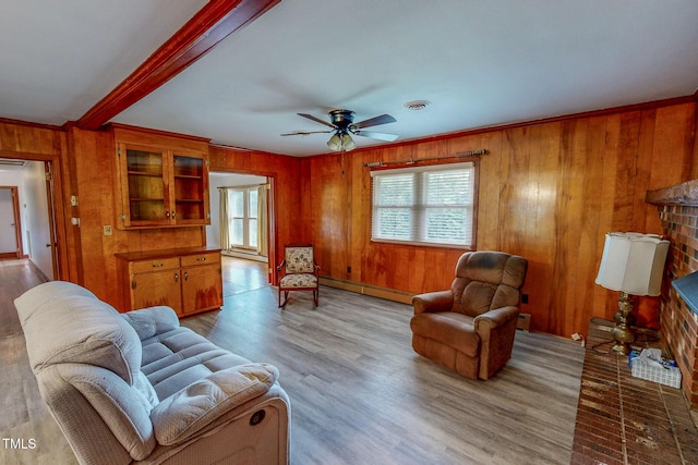 9455 Boston Rd, Roxboro, NC 27574 - living room with healthy amount of natural light, wooden walls, baseboard heating, ceiling fan, and crown molding