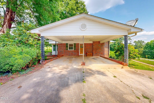 9455 Boston Rd, Roxboro, NC 27574 - view of front facade with driveway, a carport, and brick siding