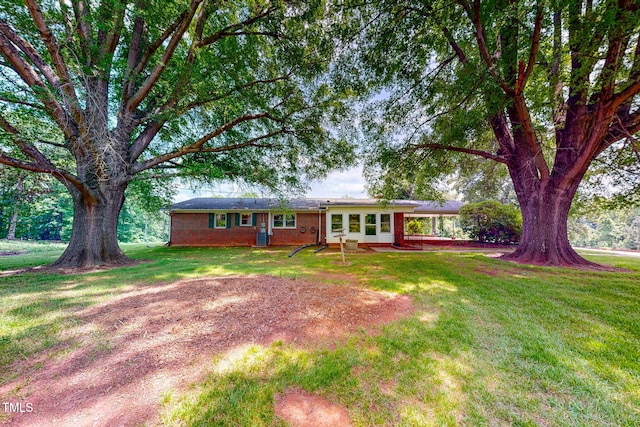 9455 Boston Rd, Roxboro, NC 27574 - ranch-style house featuring a front lawn, an attached carport, and brick siding
