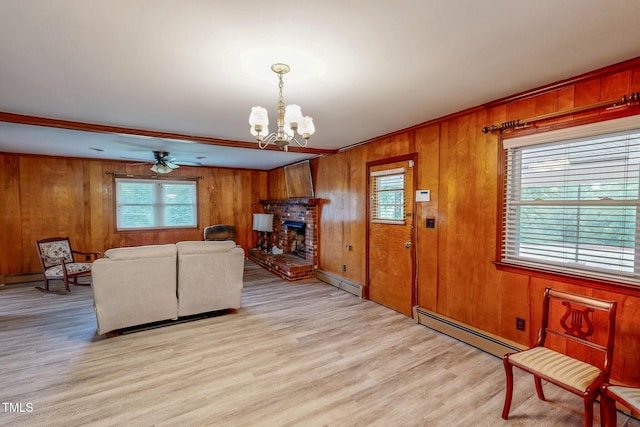 9455 Boston Rd, Roxboro, NC 27574 - living area featuring a baseboard radiator, a chandelier, wooden walls, light wood-style floors, and ceiling fan