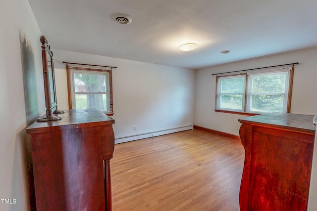 9455 Boston Rd, Roxboro, NC 27574 - unfurnished room featuring a baseboard heating unit, light wood-style floors, and baseboards