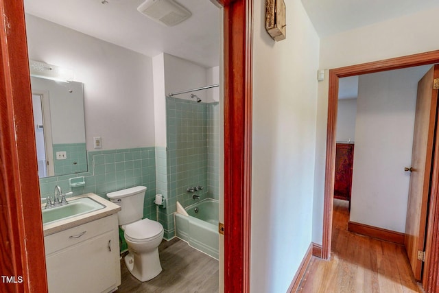 9455 Boston Rd, Roxboro, NC 27574 - full bathroom with wood finished floors, vanity, toilet,  shower combination, and wainscoting