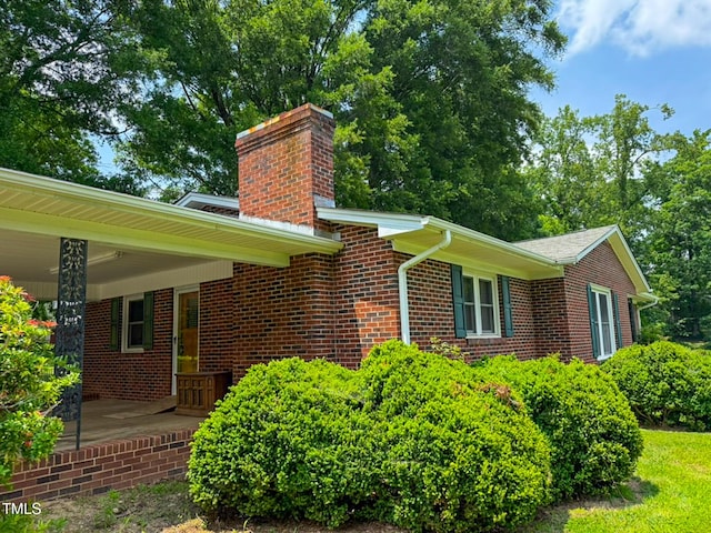 9455 Boston Rd, Roxboro, NC 27574 - view of property exterior featuring a chimney and brick siding