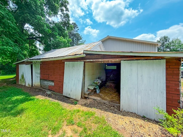 9455 Boston Rd, Roxboro, NC 27574 - view of side of property featuring an outbuilding, dirt driveway, metal roof, and a pole building