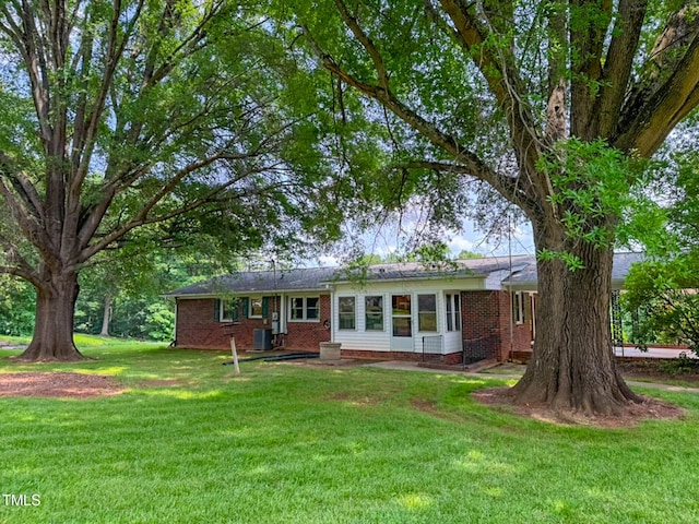 9455 Boston Rd, Roxboro, NC 27574 - ranch-style home with brick siding, a front lawn, and cooling unit