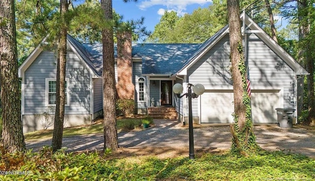 409 Thimbleberry Dr, Vass, NC 28394 - view of front of property featuring an attached garage, dirt driveway, and a chimney