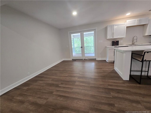 409 Thimbleberry Dr, Vass, NC 28394 - kitchen with light countertops, baseboards, dark wood finished floors, white cabinets, and recessed lighting
