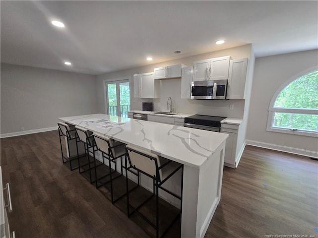 409 Thimbleberry Dr, Vass, NC 28394 - kitchen with stainless steel appliances, a kitchen breakfast bar, a sink, dark wood finished floors, and a center island