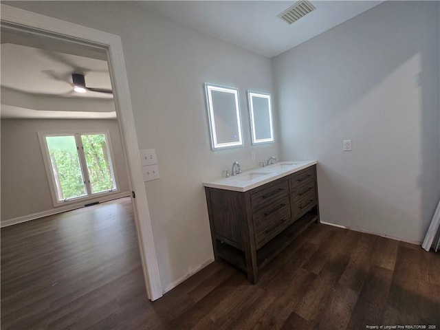 409 Thimbleberry Dr, Vass, NC 28394 - full bath featuring wood finished floors, double vanity, a ceiling fan, and baseboards