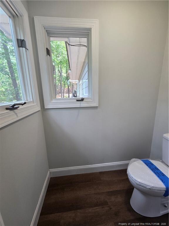 409 Thimbleberry Dr, Vass, NC 28394 - bathroom with toilet, wood finished floors, and baseboards