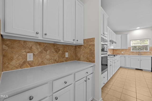 324 Farrow Glen Loop, Cary, NC 27519 - kitchen featuring light countertops, light tile patterned floors, under cabinet range hood, and white cabinetry