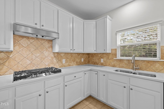324 Farrow Glen Loop, Cary, NC 27519 - kitchen featuring under cabinet range hood, a sink, stainless steel gas stovetop, white cabinetry, and light countertops