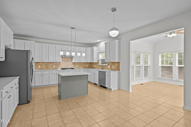 324 Farrow Glen Loop, Cary, NC 27519 - kitchen featuring stainless steel appliances, backsplash, light countertops, a kitchen island, and ceiling fan