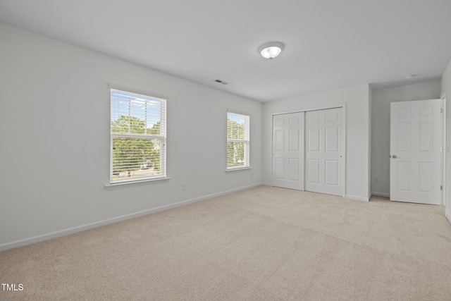 324 Farrow Glen Loop, Cary, NC 27519 - unfurnished bedroom with baseboards, light colored carpet, and a closet