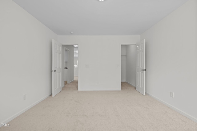 324 Farrow Glen Loop, Cary, NC 27519 - unfurnished bedroom featuring light colored carpet, a spacious closet, and baseboards