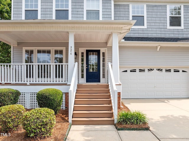 324 Farrow Glen Loop, Cary, NC 27519 - doorway to property with an attached garage, concrete driveway, roof with shingles, and covered porch