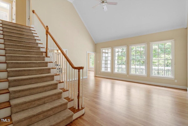 1211 E Pointe Dr, Durham, NC 27712 - staircase featuring wood finished floors, high vaulted ceiling, baseboards, ceiling fan, and ornamental molding