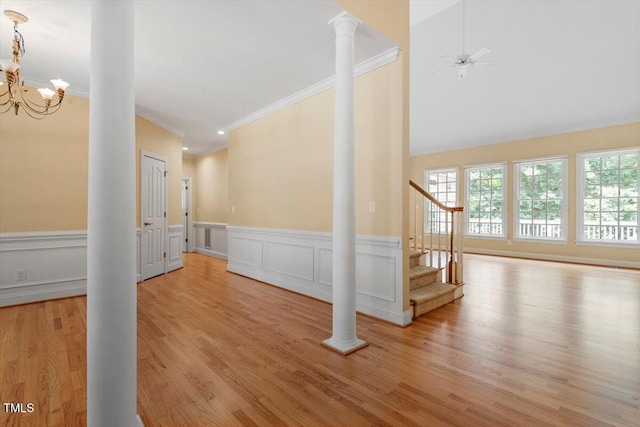 1211 E Pointe Dr, Durham, NC 27712 - unfurnished living room featuring ornate columns, ornamental molding, plenty of natural light, a chandelier, and wood finished floors