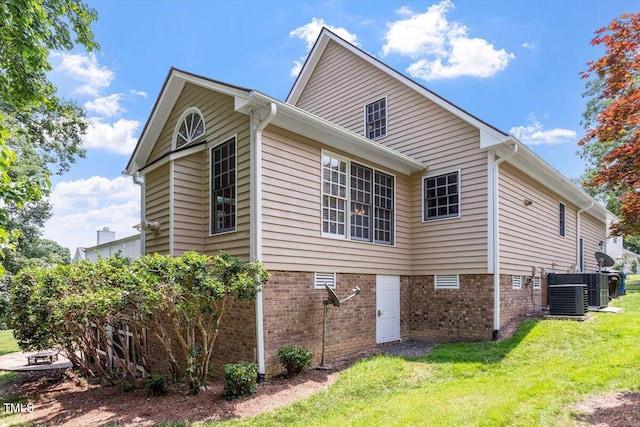 1211 E Pointe Dr, Durham, NC 27712 - view of home's exterior with a lawn, central AC unit, and brick siding