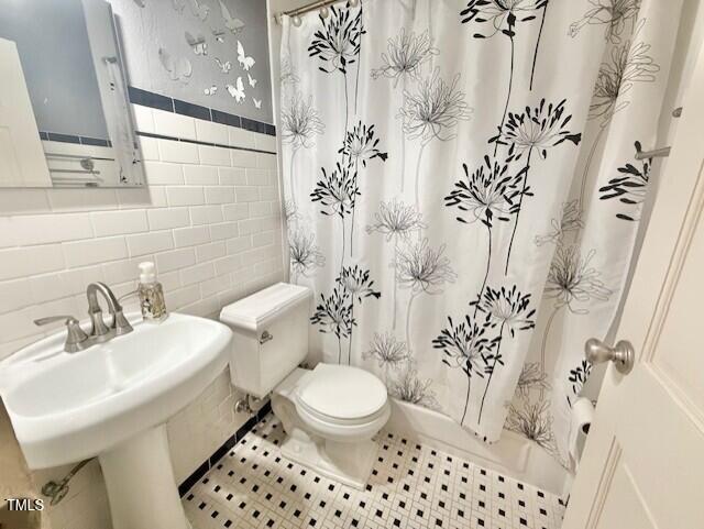 1112 N Driver St, Durham, NC 27701 - full bathroom with tile walls, toilet, shower / bath combo, and a sink